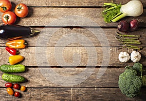 Exposition of fresh organic vegetables on wooden table. tomato, pepper, broccoli, onion, garlic, cucumber,  eggplant, black Eyed P