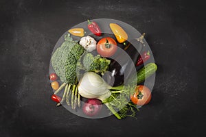 Exposition of fresh organic vegetables on wooden table. tomato, pepper, broccoli, onion, garlic, cucumber,  eggplant, black Eyed P