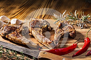 Exposition of mutton, fried lamb, barbecue lamb on wooden plate with chili pepper and garlic on wooden table.