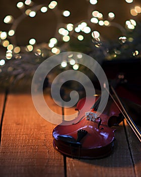 Exposition of violin and background with Christmas tree with light, very beautiful composition, the best day in the year.