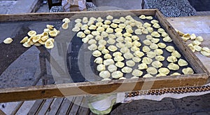 Exposure of the famous Apulian orecchiette, a type of fresh handmade pasta on the street by housewives in Bari Vecchia, Apulia,