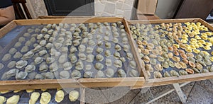Exposure of the famous Apulian orecchiette, a type of fresh handmade pasta on the street by housewives in Bari Vecchia, Apulia,