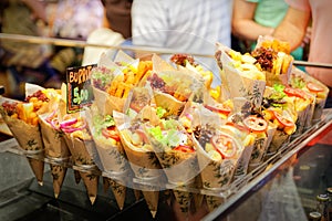 Exposure ordered burrito in paper cones ready for sale to tourists in Barcelona