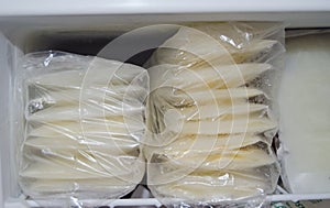 Expresed breast milk packed in storage bags and frozen in the freezer