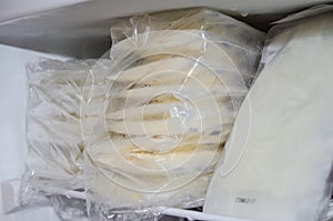 Expresed breast milk packed in storage bags and frozen in the freezer