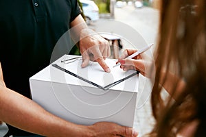 Express Delivery. Courier Delivering Package To Woman