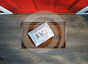 Express envelope package delivered to residential front door.