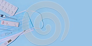 Express negative Langya henipavirus LayV test,Schnelltest, medical mask, syringe,thermometer,medicine on a blue background.The photo