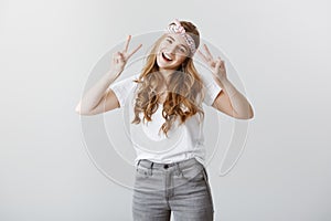 Expressing positive emotions. Portrait of charming sincere caucasian female model in stylish clothes and bright headband