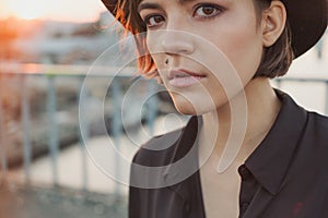 Expressive attentive look girl teenager in black hat.