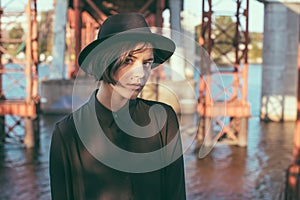 Expressive attentive look girl teenager in black hat.