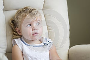 Expressive Blonde Haired and Blue Eyed Little Girl in Chair