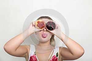 Expressive blonde woman holding sweet dessert with berries and c photo