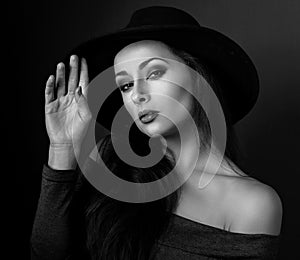 Expressive bright makeup woman in fashion elegant hat posing on