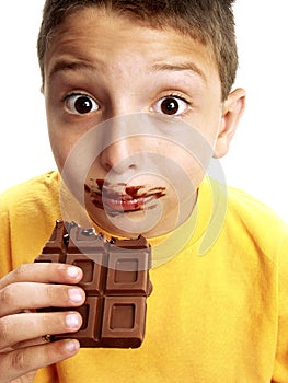 Expressive child eating chocolate