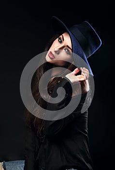 Expressive female model posing in black shirt and elegant h