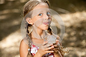 Expressive girl drinking milkshake.