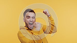 Expressive and happy young man over vibrant background. Portrait of the person who won.