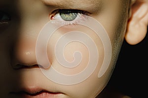 Expressive look of a small child. Baby's eye close-up. Gray green iris