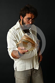 Expressive man gesturing with book