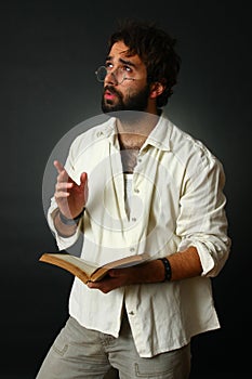 Expressive man gesturing with book