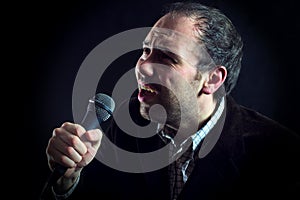 Expressive man singer with microphone