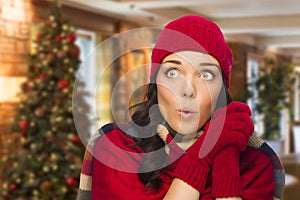 Expressive Mixed Race Girl Wearing Mittens and Hat In Christmas Setting