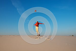 Expressive young woman, with open arms, blonde walks in the desert