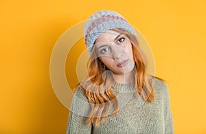 Expressive young woman posing, isolated on yellow background. Pretty girl. Front view