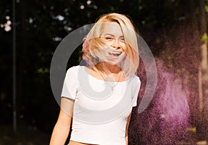 Expressive young woman in white t shirt with hair in wind posin