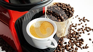 Expresso coffee machine with fresh brewed coffee and roasted beans in white cup