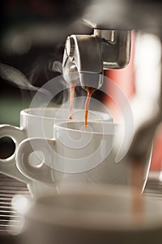 Expresso machine pouring two coffees photo