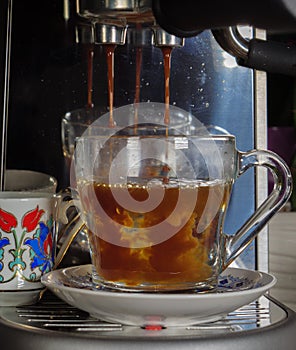 Expresso poured over hot water to make cafe americano photo