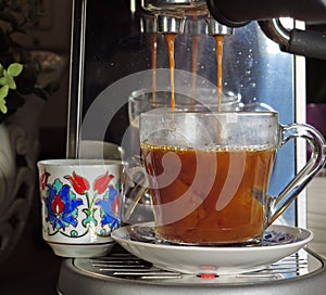 Expresso poured over hot water to make cafe americano photo