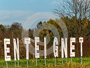 Expropriates lettering on a field photo