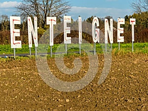 Expropriates lettering on a field photo