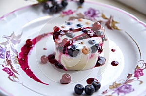 Exquisite dessert - a cool jelly with fresh berries on a light plate