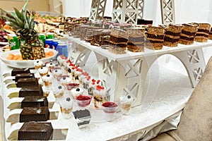 Exquisite festive table with sweets and fruits.