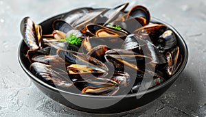 Exquisite mediterranean style grilled mussels elegantly presented on a sleek black plate