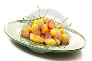 Roast potatoes dish on white background
