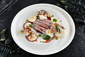 Restaurant Plate of Black Angus Beef Fillet with Warm Potatoes in Cheese Sauce and Mushroom Espuma photo