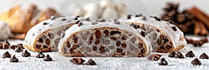 Exquisite stollen bread close up on white tabletop with elegant glistening frosting layer