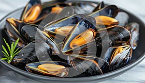 Exquisite traditional mediterranean grilled mussels served on a refined black plate