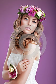 Exquisite Woman with Wreath of Flowers. Elegant Lady with Frizzy Hair