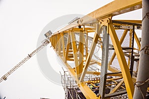 Exteme angle of yellow construction tower crane