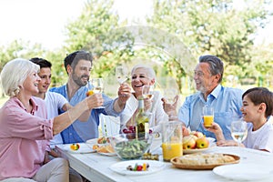 Extended family eating outdoors