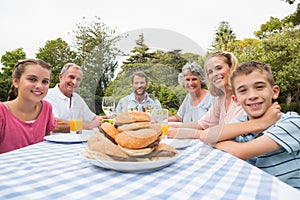 Extended family eating outdoors at picnic table