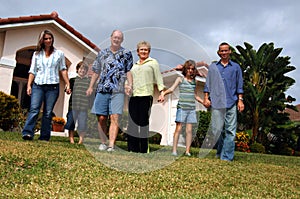 Extended family in front of home