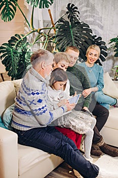 Extended family looking at the screen of the computer