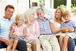 Extended Family Relaxing Together On Sofa